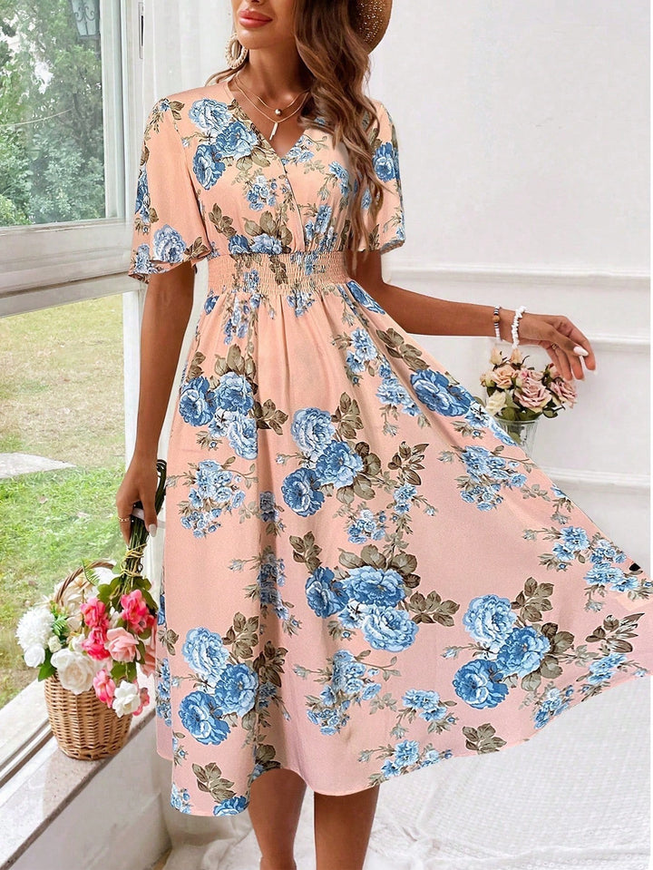 Pink floral midi dress with blue rose print and V-neckline