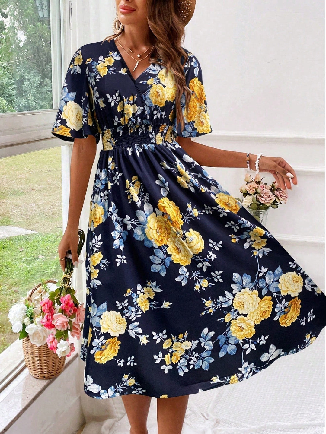 Navy floral midi dress with yellow rose print and flutter sleeves