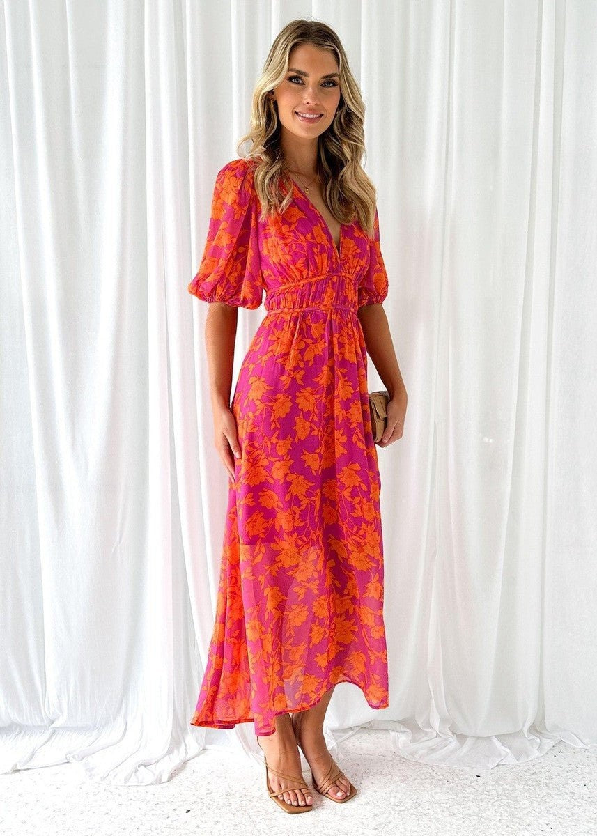 Model wearing floral puff-sleeve midi dress with fitted waist detail