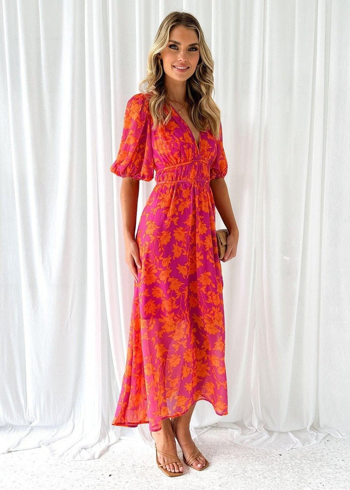 Model wearing floral puff-sleeve midi dress with fitted waist detail
