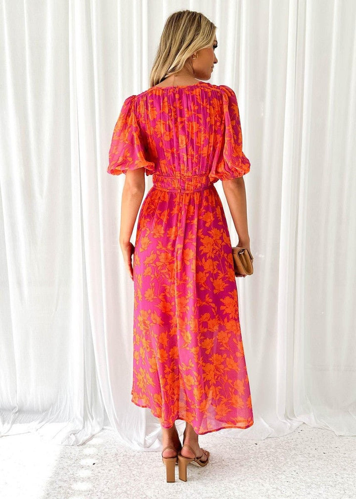 Back view of pink floral midi dress showing elasticated waist and puff sleeves