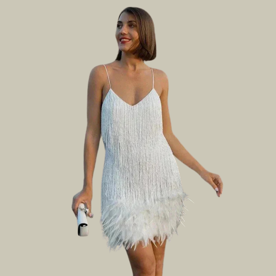 Ivory tassel mini dress featuring feather trim, styled with a white clutch