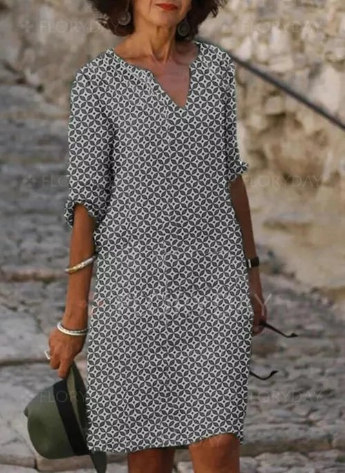 Grey geometric print shift dress featuring V-neck and turned-up cuffs