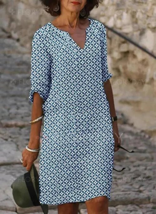 Blue and white patterned midi dress with split neckline and pockets