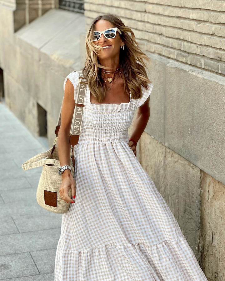 Close-up of smocked bodice on beige gingham flutter sleeve maxi dress