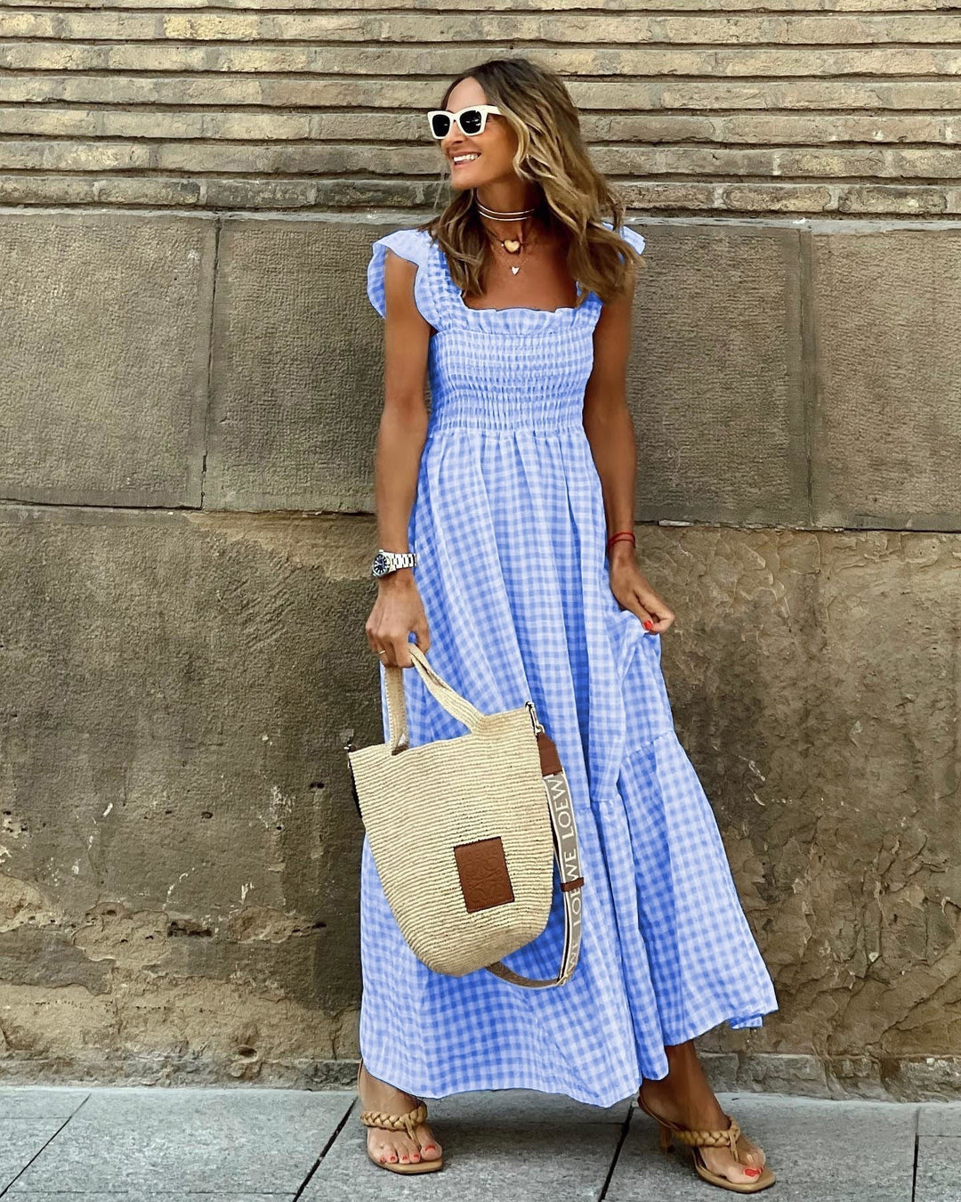 Blue gingham flutter sleeve maxi dress styled with straw tote and sandals