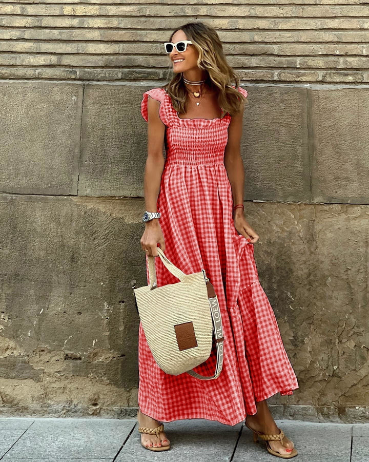 Red gingham flutter sleeve maxi dress paired with woven tote bag