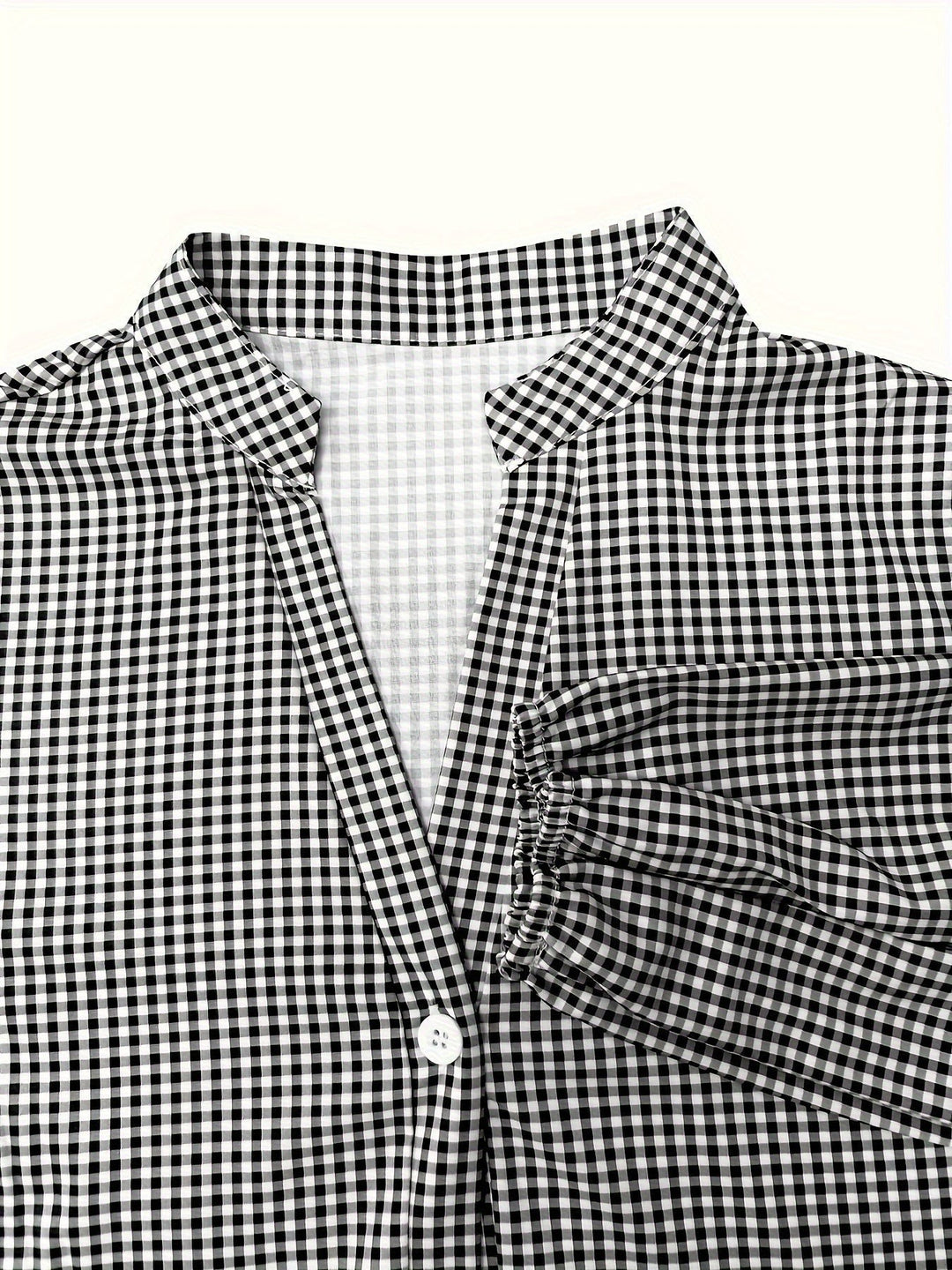 Close-up of black and white gingham collar and button placket detail