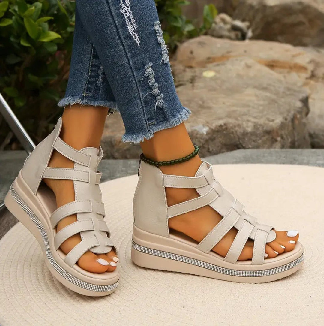 Beige gladiator wedge sandals with woven straps and sparkly platform edge