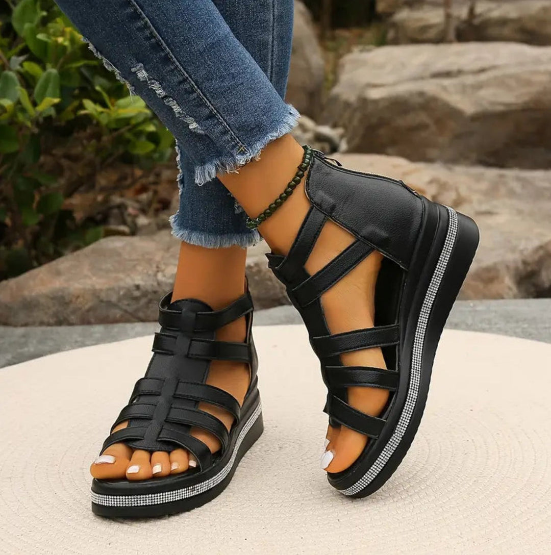 Black caged wedge sandals with multi-strap upper and rhinestone platform
