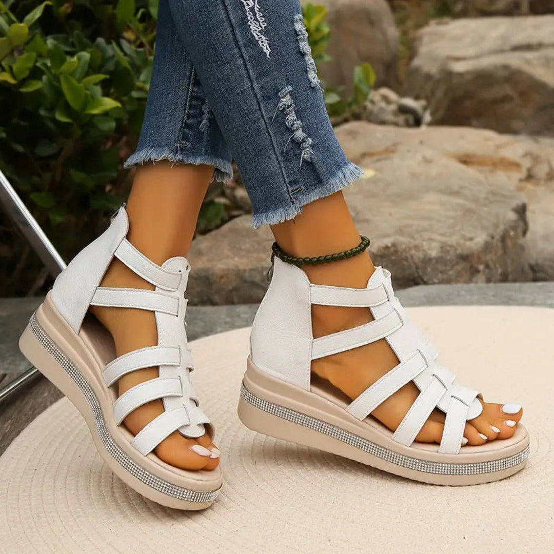 White gladiator sandals showing strappy cage upper and rear zip fastening