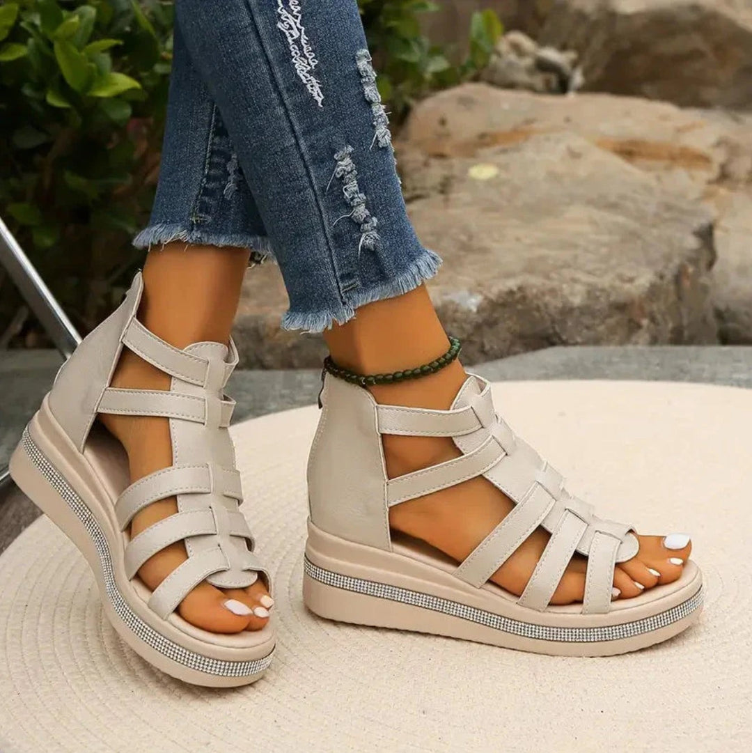 Beige caged gladiator sandals with woven straps and glittery platform sole