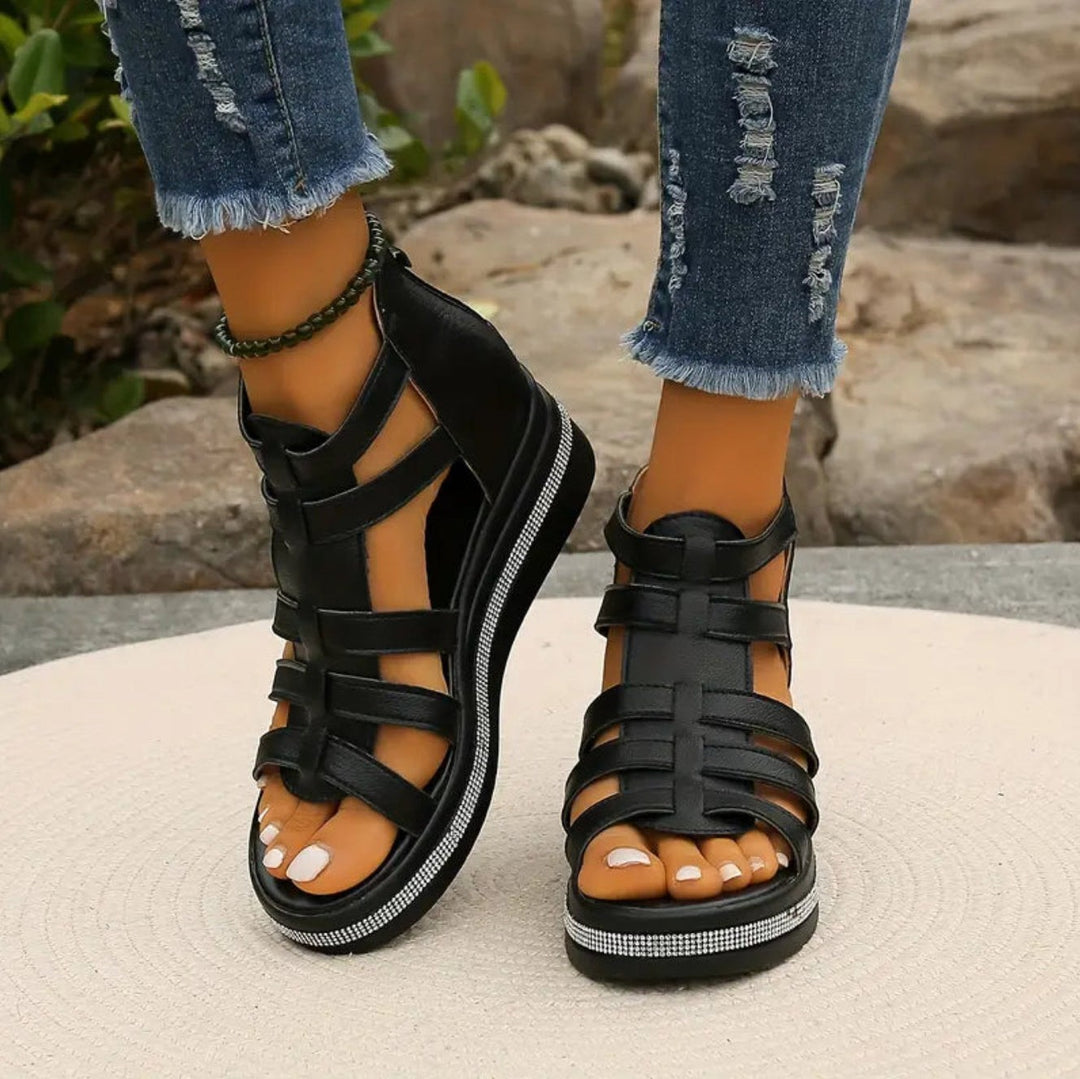 Black gladiator wedge sandals with cut-out straps and sparkly platform detail