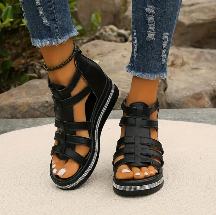 Black gladiator wedge sandals with cut-out straps and sparkly platform detail