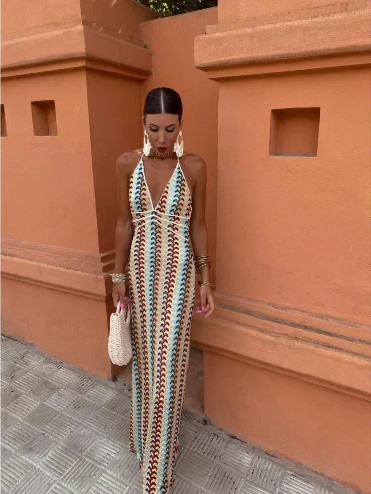 Multicoloured crochet-knit maxi dress with plunging halter neckline and straw bag