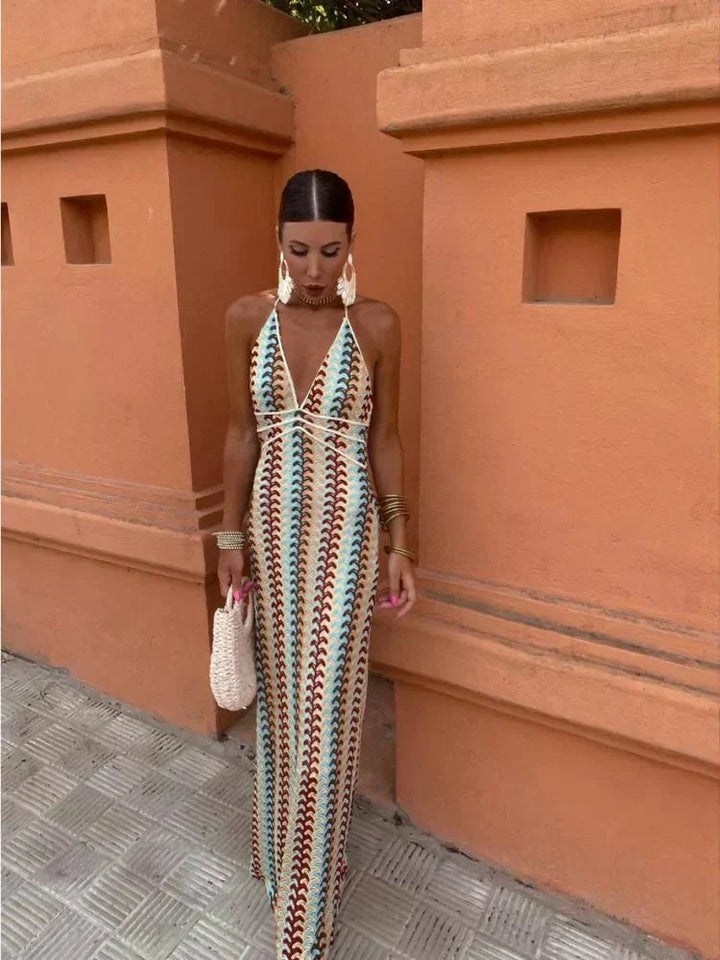 Multicoloured crochet-knit maxi dress with plunging halter neckline and straw bag