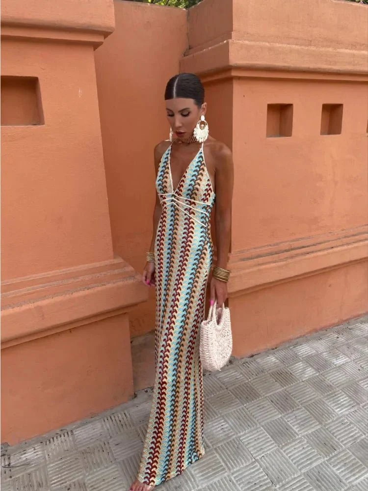 Front view of striped crochet halter maxi dress worn with statement earrings