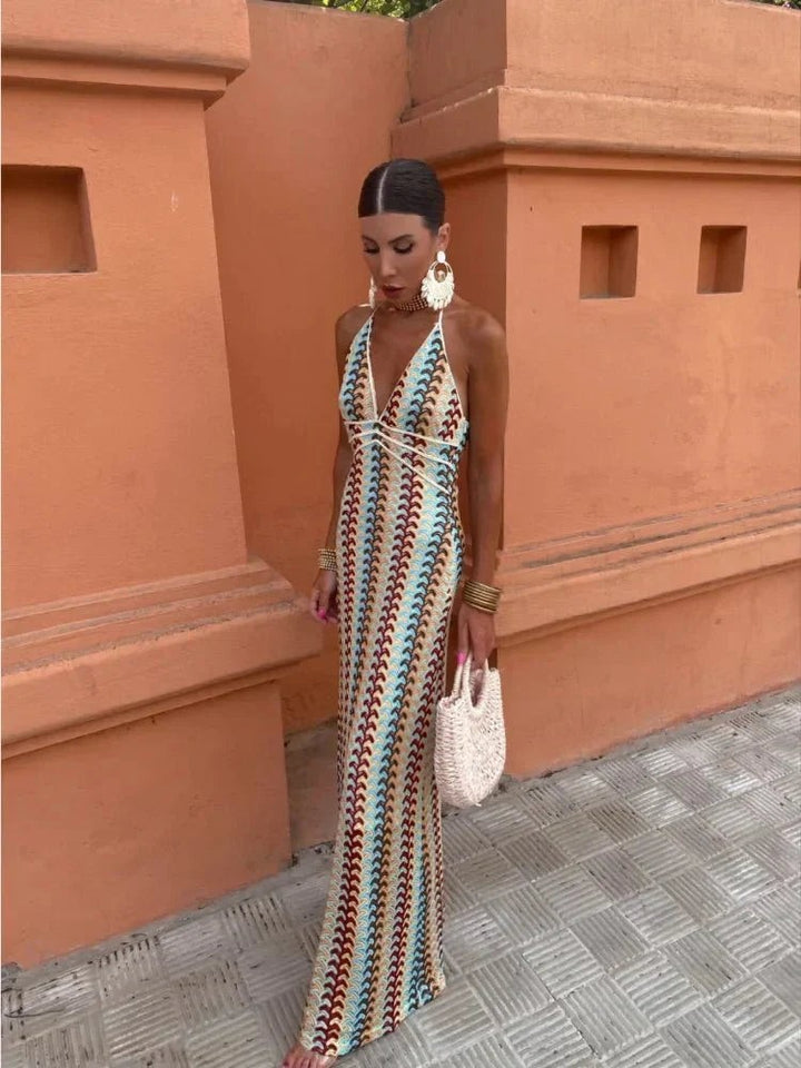 Front view of striped crochet halter maxi dress worn with statement earrings