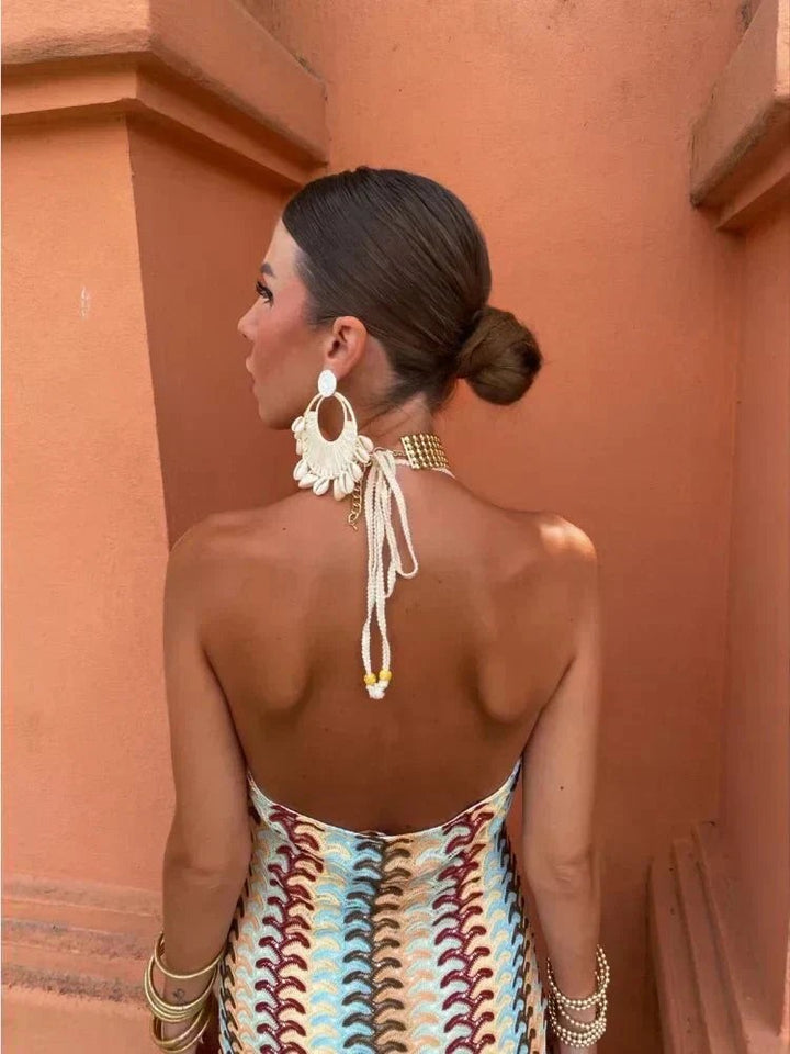 Rear view of halterneck maxi dress highlighting bare back and beaded straps