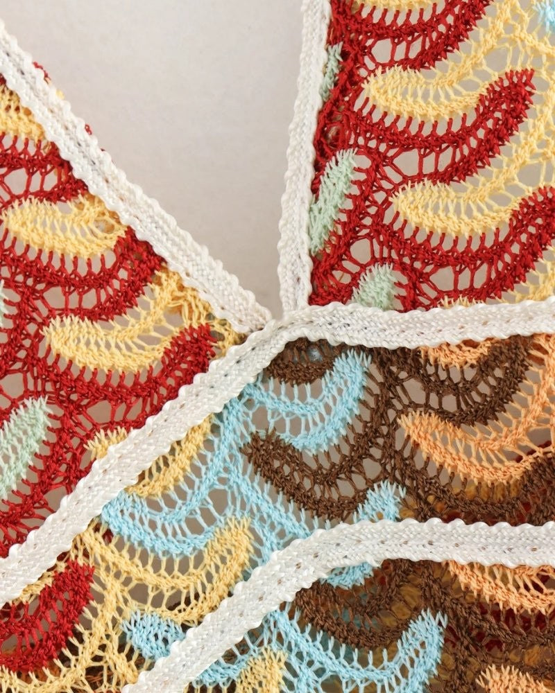 Close-up of multicoloured chevron crochet fabric with cream trim detailing