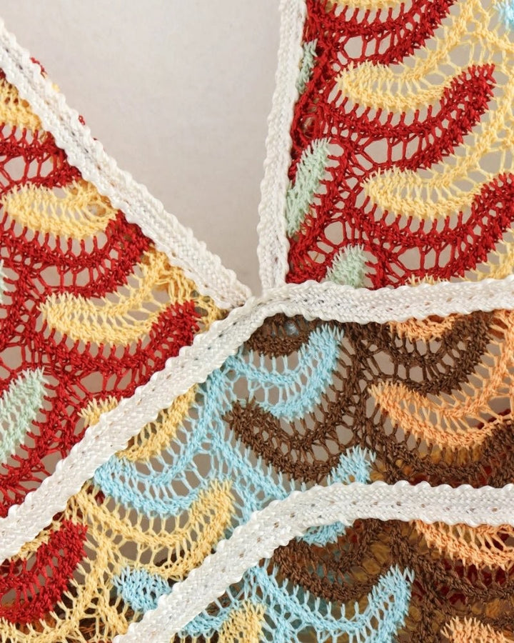 Close-up of multicoloured chevron crochet fabric with cream trim detailing