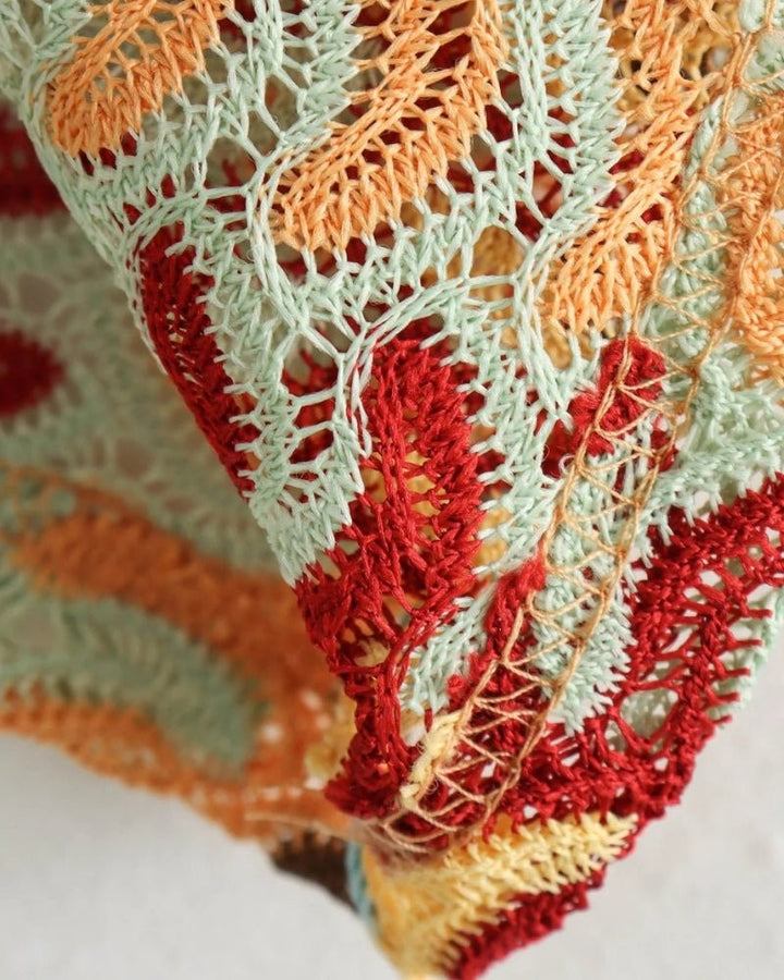 Textured knit swatch showing red, orange and mint chevron crochet pattern