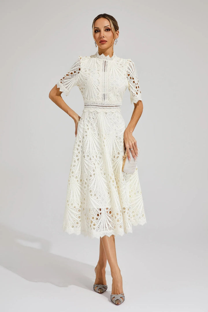 Ivory lace midi dress paired with a pleated satin clutch bag