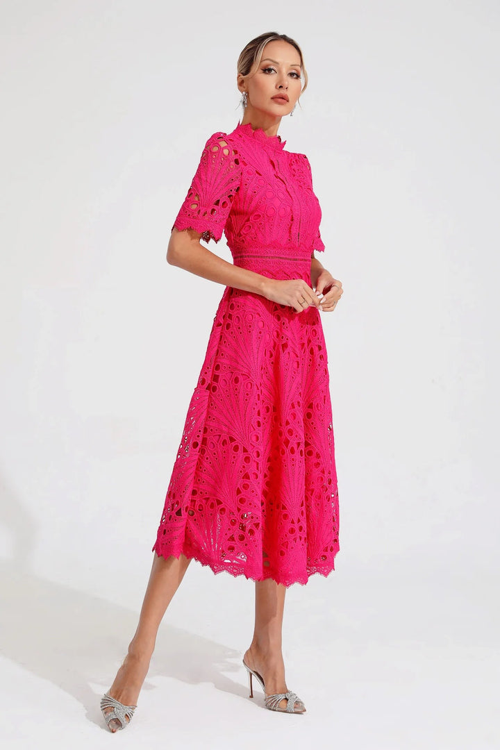 Hot pink lace midi dress shown in a relaxed walking pose