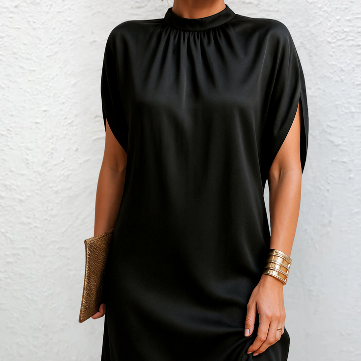 Close-up of black high neck mini dress showing draped satin fabric