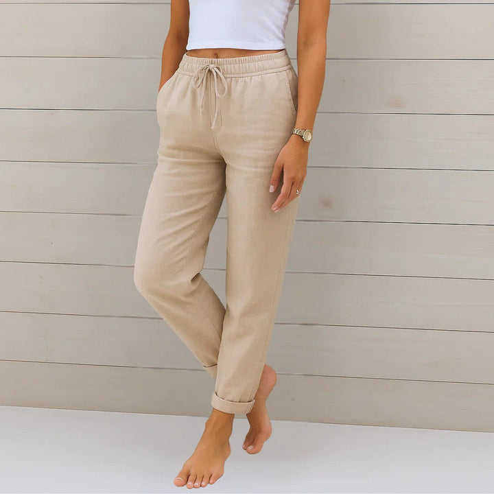 Beige linen-blend trousers with drawstring waist and turned-up cuffs
