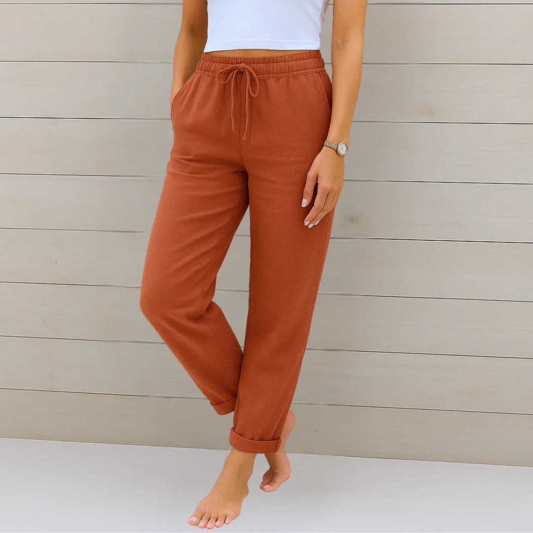Rust orange linen-blend trousers with drawstring waist and folded ankle cuffs