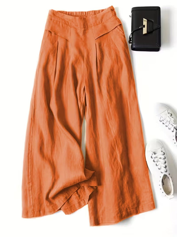 Burnt orange wide-leg linen trousers with pleated waist and elasticated back