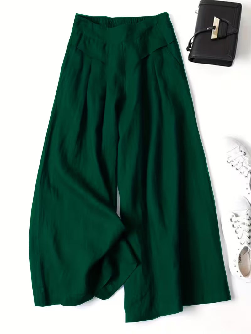 Emerald green wide-leg trousers featuring pleated front and elasticated waistband