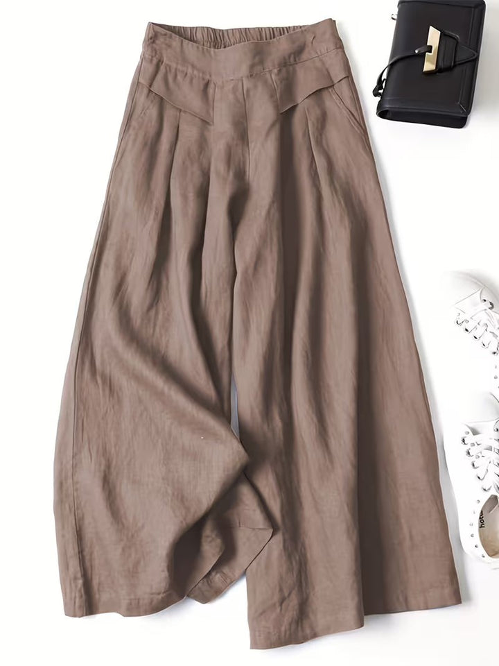 Taupe wide-leg linen trousers with pleated detailing and side pockets