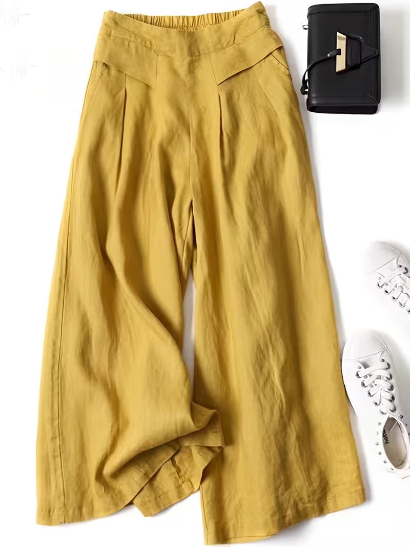 Golden yellow wide-leg linen trousers with pleated front and relaxed fit