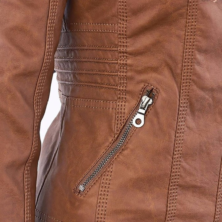 Close-up of tan faux-leather jacket sleeve seam with quilted stitching detail