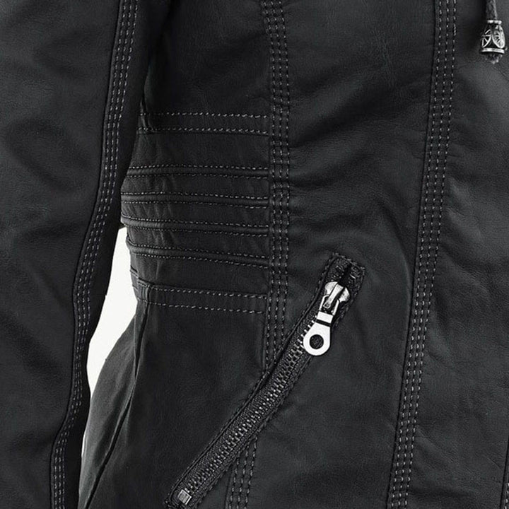 Close-up of black faux-leather jacket seam with quilted panel stitching