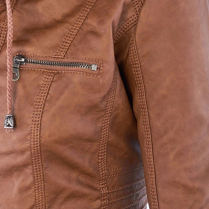 Close-up of tan faux-leather jacket showing zip pocket and braided pull