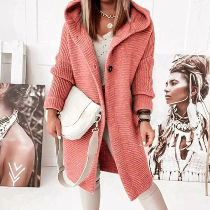Longline coral knit cardigan with hood, styled with cream trousers and handbag