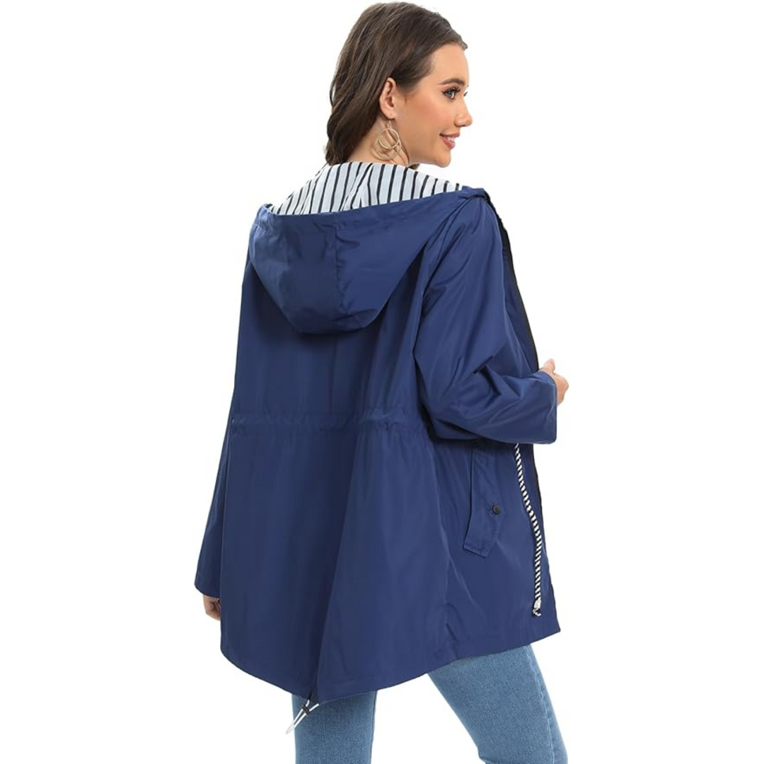 Rear view of woman wearing navy hooded jacket with striped trim