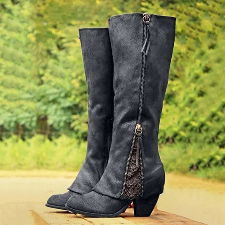 Black knee-high boots featuring block heel and lace zip trim