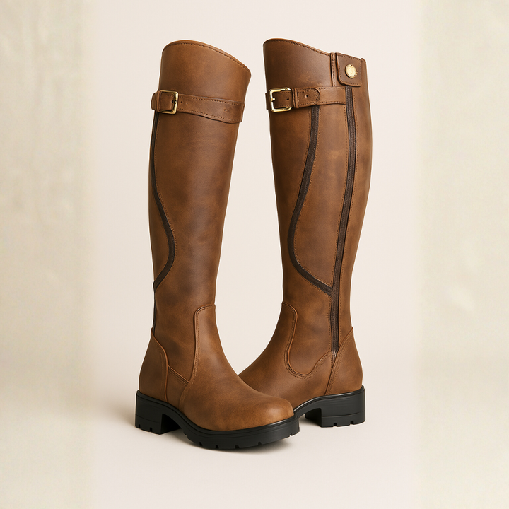 Tan leather knee-high boots with buckle strap and chunky black sole