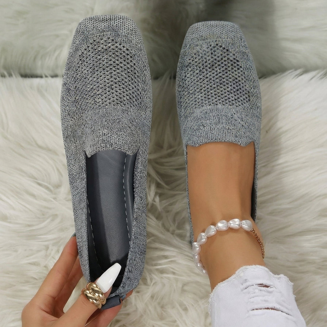 Grey knitted flat loafers with perforated toe detail and slip-on style