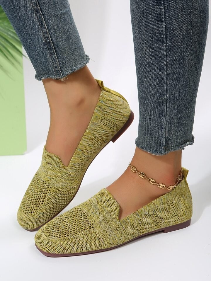Mustard yellow knitted flat loafers paired with cropped skinny jeans