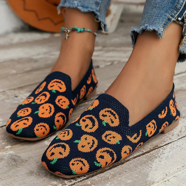 Navy knitted loafers decorated with orange pumpkin print pattern