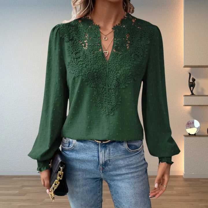 Dark green lace-trim blouse featuring V-neckline and dotted fabric texture