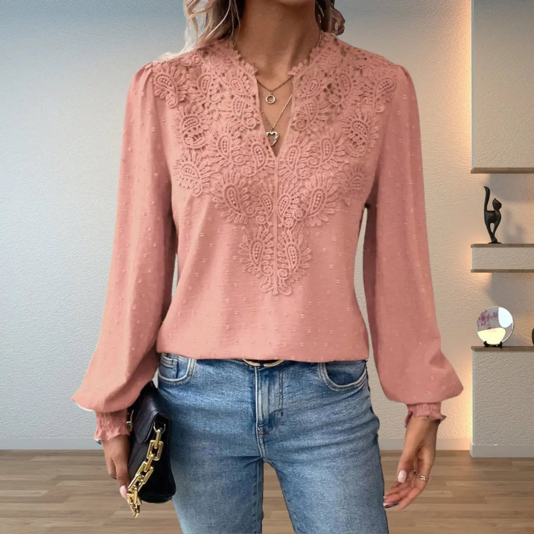 Blush pink lace-detail blouse featuring V-neck and ruffled cuffs
