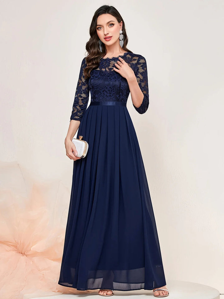 Navy lace maxi dress featuring quarter sleeves and flowing pleated skirt