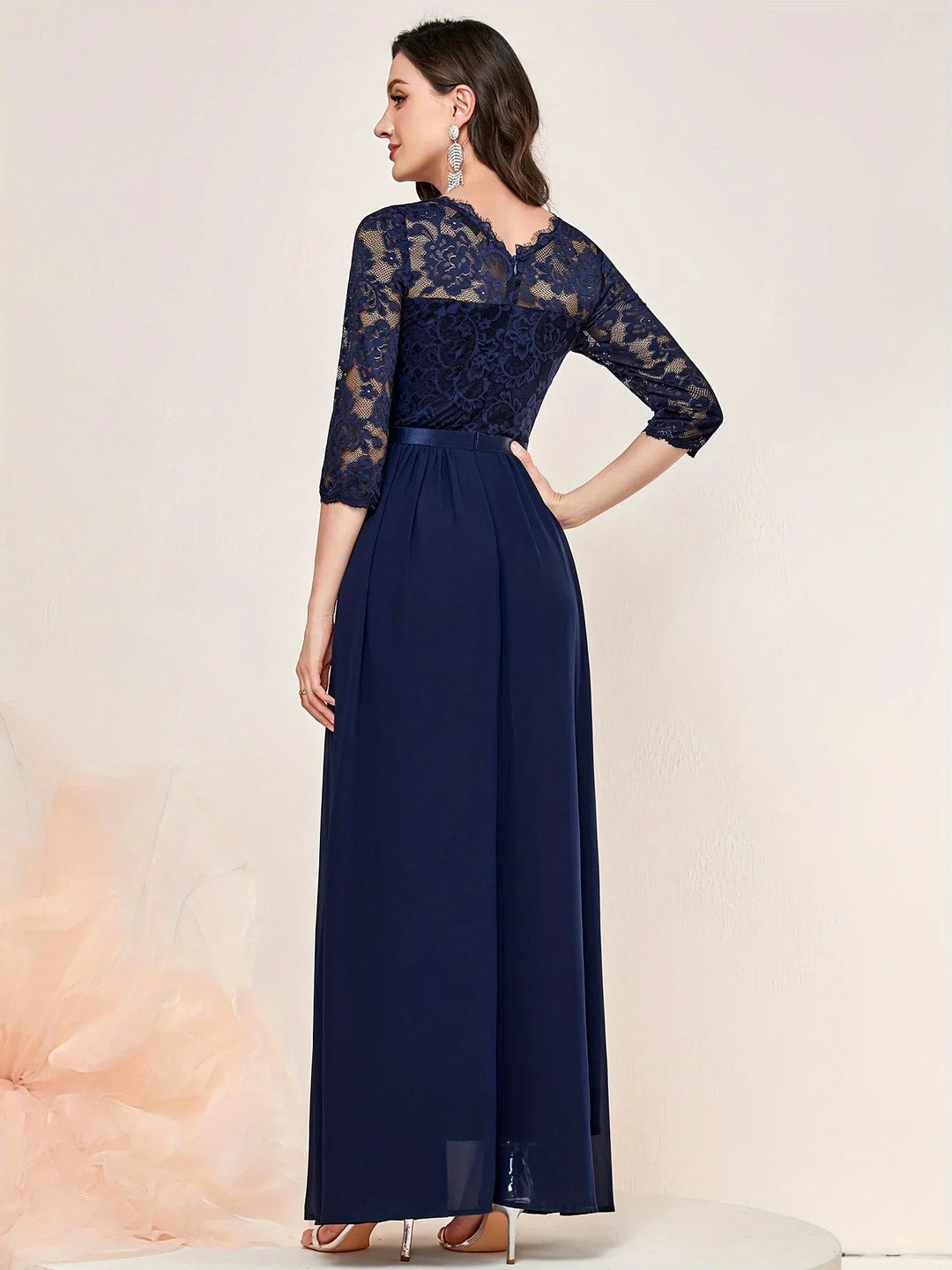 Navy lace evening dress showing scalloped back neckline and pleated skirt detail