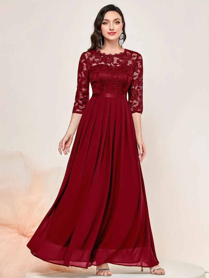 Burgundy lace evening dress featuring sheer sleeves and flowing pleated skirt